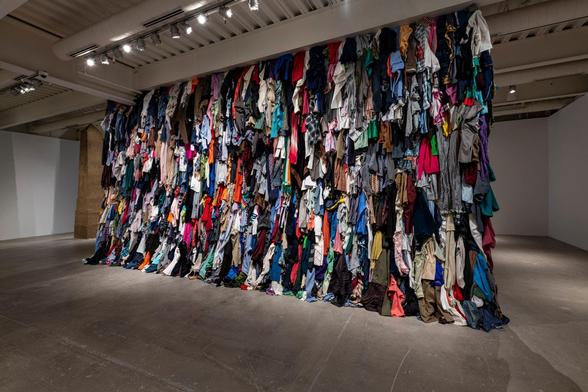Wall (installation views) by Karyn Olivier, 2017-2018 (clothes, bricks)
A brick wall with various items of clothing squeezed between the horizontal layers.