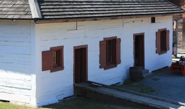 Historic post and sill building of the HBC fur trade, whitewashed and shingle roofed. This is the old storehouse at replica Fort Langley.