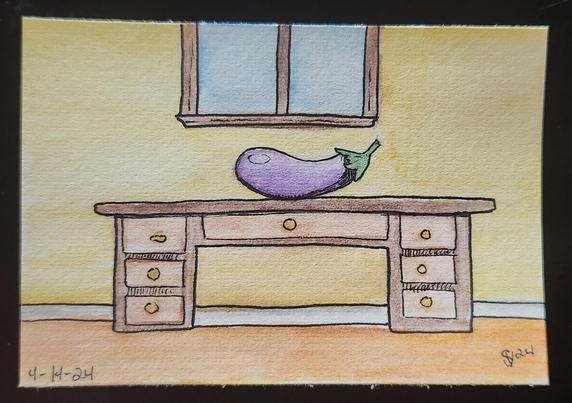 Giant eggplant sitting on a desk