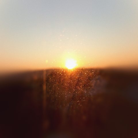 Playlist cover showing a sunrise captured through a window.