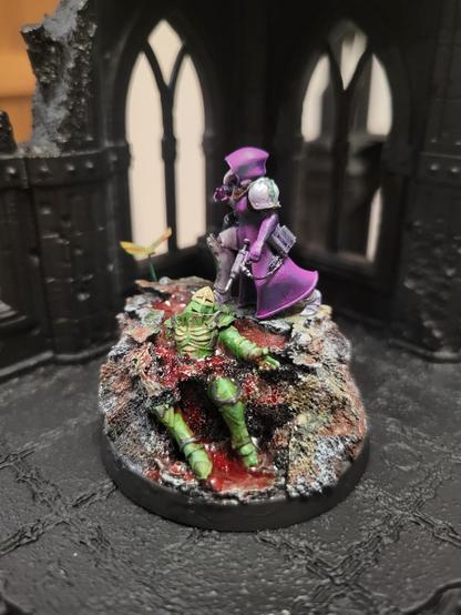 Green armored battle sister being helped by purple robed hospitaller