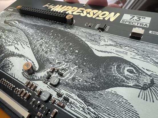Backside of the Inky Impression Spectra board. Showing a seal Printen on the pcb. You can see some components and the 40-pin connector on the board