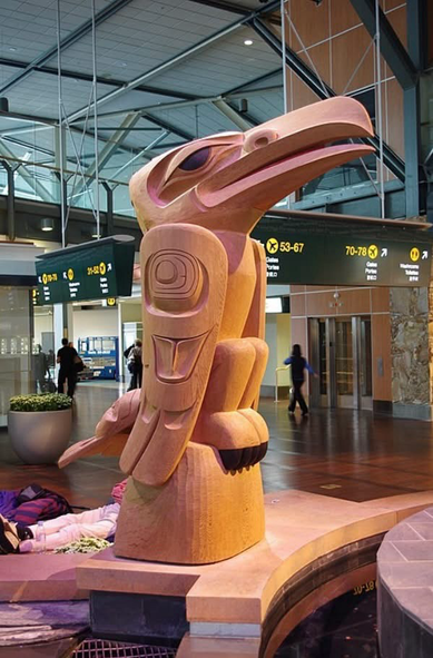 Fog Woman and the Raven by Dempsey Bob. This piece can be viewed in the Vancouver Airport.