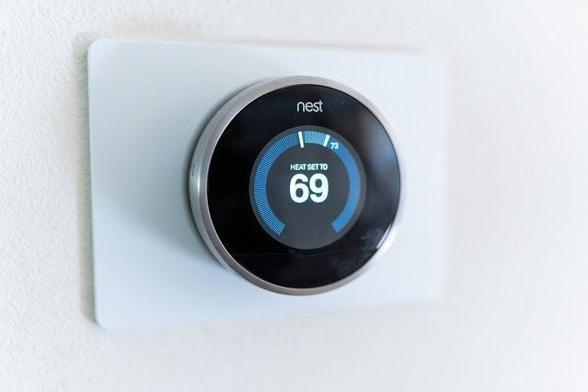 Nest learning thermostat on the wall.