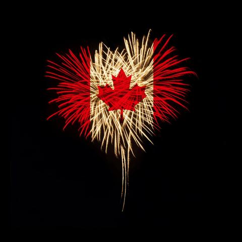 The Canadian Flags appears out of exploding fireworks against a dark sky.
(Image licensed from Deposit Photo)