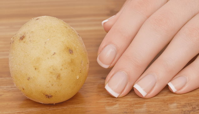 A potato and some hands with perfect manicures