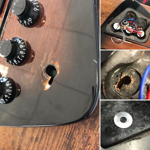 The image shows a close-up of a damaged electronic device, possibly a guitar. It features several controls with numbers, a visibly broken area with a hole, and components inside the casing, including wires. There’s also a loose metal washer displayed in one.