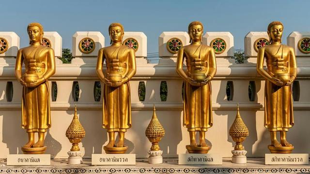 Statues of four monastics.