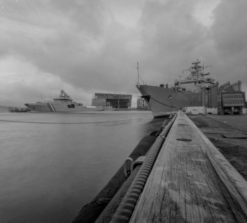 Black and white picture from the harbor in Reykjavík showing two ships, one is the Icelandic coast guard and the other a German warship.  Shot with a pinhole camera.