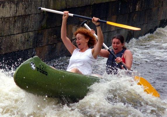 letting go of control at a conference: Two women joyfully kayaking through turbulent water. Image attribution: flickr user donaldjudge