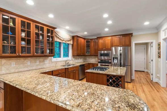 Modern kitchen in UAE featuring Steel Grey Granite countertop, offering durability, style, and heat resistance.