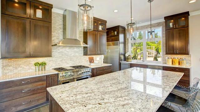 Modern kitchen in UAE featuring Steel Grey Granite countertop, offering durability, style, and heat resistance.