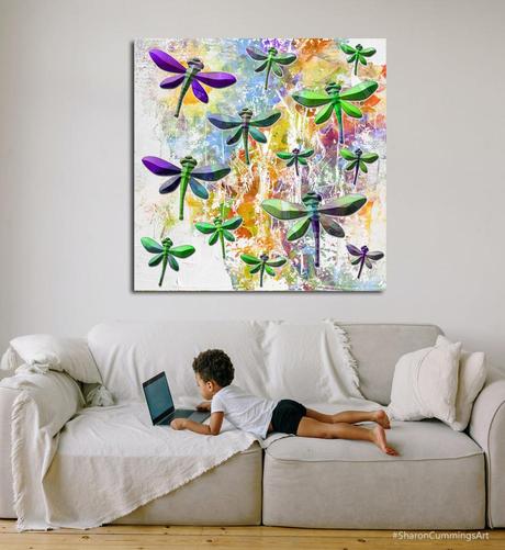 Colorful dragonflies over white and rainbow colors.  Set over a sofa with a little boy on a laptop.  Art and poetry by Sharon Cummings.