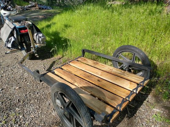 Photo of the same trailer set up taken from the back of the trailer towards the bike. You can see the decking and lashings more clearly here.