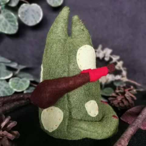 The back of the plushie; you can see that it has a wooden club attached to it’s back. 