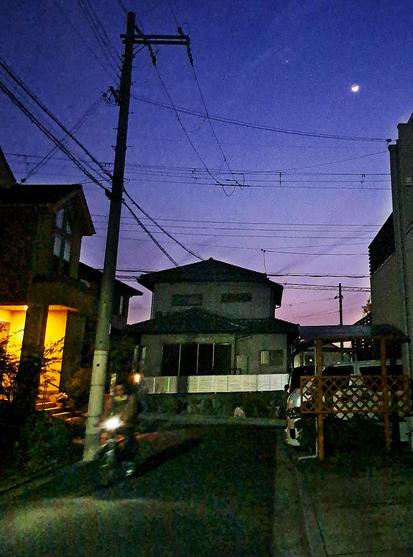 Venus and the Moon at 7pm in Osaka. A guy on a bike is coming home with his bright bike light on.