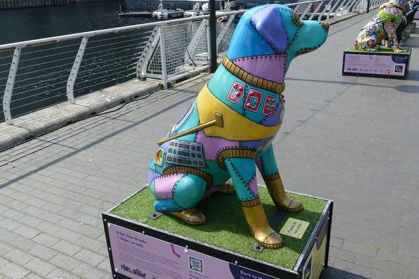 A photo titled "'Bark to the Future' by Glen Brooks, West India Quay, Paws on the Wharf", taken near Bridge, West India Quay Footbridge by Loz Flowers on Flickr.