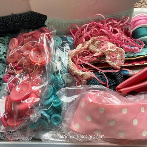 Bucket of teal & rose trims, ribbons & buttons. 
