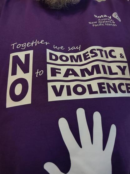 A purple tshirt with the words No to domestic and family violence.