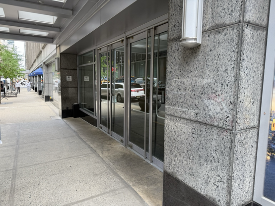 Glass hotel doors on a midtown NYC sidewalk