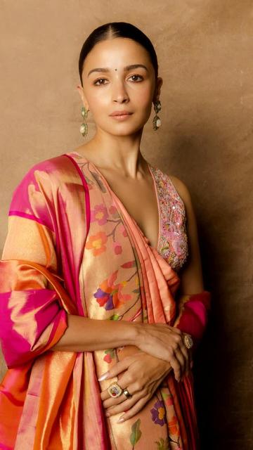 Alia Bhatt stuns in a peach Paithani saree at the Wave Summit, celebrating Indian craftsmanship. The saree, featuring golden zari borders and floral motifs, is paired with a resham-embroidered blouse. Her look, styled by Ami Patel and captured by Gourab Ganguli, is a tribute to Maharashtrian heritage.