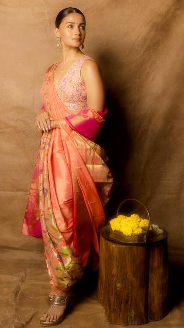 Embracing traditional elegance, Alia Bhatt dons a peach Paithani saree at the Wave Summit. Handwoven by Yeola artisans, the saree's intricate designs are complemented by a resham-embroidered blouse. Her look, enhanced by jasmine-adorned hair and Chandbali earrings, celebrates India's rich textile legacy.