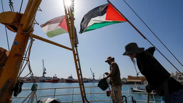 Activists aboard a Freedom Flotilla Coalition in Malta, August 2024.  (Reuters: Darrin Zammit Lupi), flying Palestinian flag.