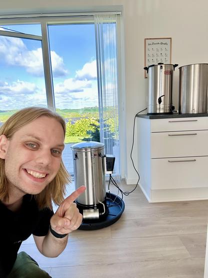 Me sitting in front of homebrewing equipment.