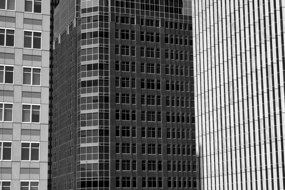 Black and white image of the windows of three different buildings in downtown Des Moines, Iowa. 