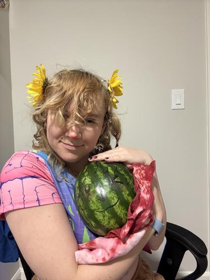 Yucan holding watermelson to show everyone the baby