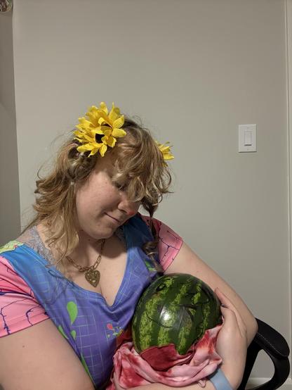 Holding the newborn watermelson like a baby