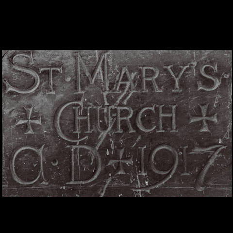 Stone carved with words "ST. MARY'S CHURCH A.D. 1917" and punctuated with crosses