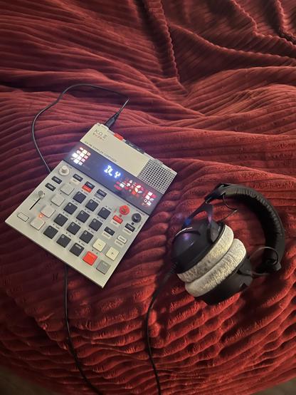 KO II laying on a bean bag with headphones.