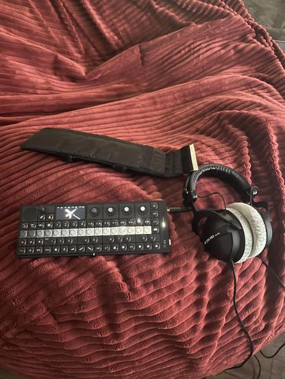 OP-XY sitting on a beanbag.