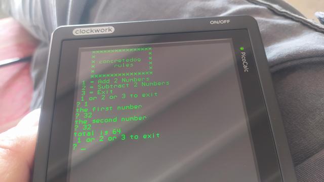 Photo of my Picocalc screen. It shows a rudimentary "program" running with a text based menu offering options to add 2 numbers, subtract 2 numbers or exit.