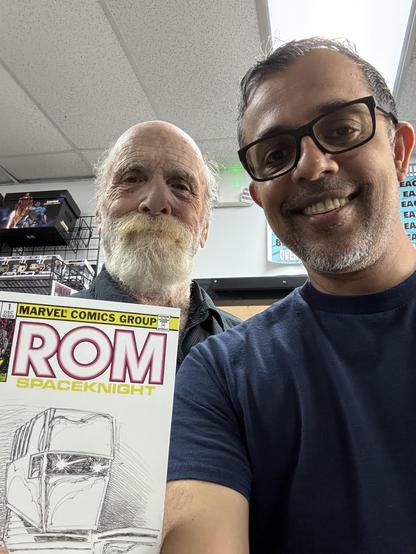 A photo of yours truly with Pat Broderick. I’m holding the sketch cover he drew for me.