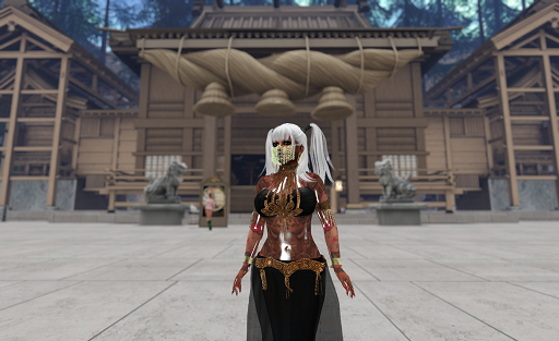 A heavily tattooed woman with long white hair tied into pigtails stands in a paved square. She is wearing a black bikini top with gold beaded straps, arm bands with gold tassels, bronze bracelets, and a long black skirt with a gold belt. She also has a gold chain face mask. Behind her at the far side of the square is a large wooden building in a classic Japanese style. Massive shiminawa hanging from the eves. Lion statues bracket the entrance.