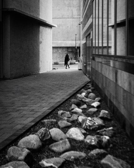 Black and white picture  from downtown Reykjavík. A person is walking in the distance.
