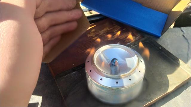 The stove lit. You can see the jets just, a small ball bearing covers the central fill hole. 