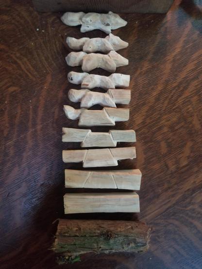 a sequence of woodcarvings illustrating the various steps between An Unstripped Branch Section (#1) and A Small Wooden Fox (#11)