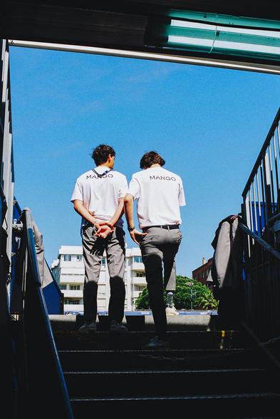 2 - Film, shot on Ultramax 400. Photograph of two people at the end of the stairs leading to the stands of a tennis court.