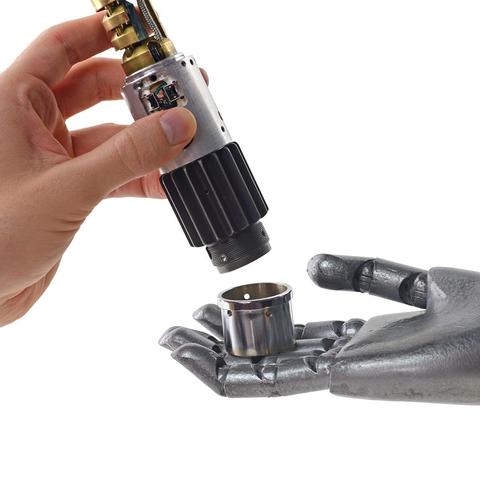 A metallic human right hand on the right of the image is holding the end-piece of the lightsaber hilt, while a real human left hand holds the rest of the lightsaber above it, indicating the end-piece was just removed/fell into the metallic hand.