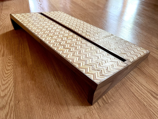 Back view of a two tiered guitar pedal board with patterned plywood and walnut. There is space in the back for cable runs