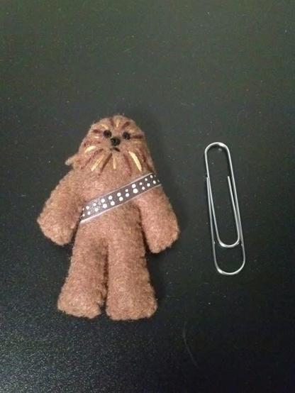 Tiny handmade Chewie next to a paperclip for size comparison.