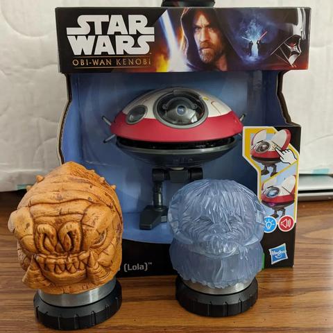 Lightsabre pomels of rancor and wampa in front of Lola (droid) toy.