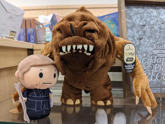 Itty bitty plush of Luke Skywalker and rancor.