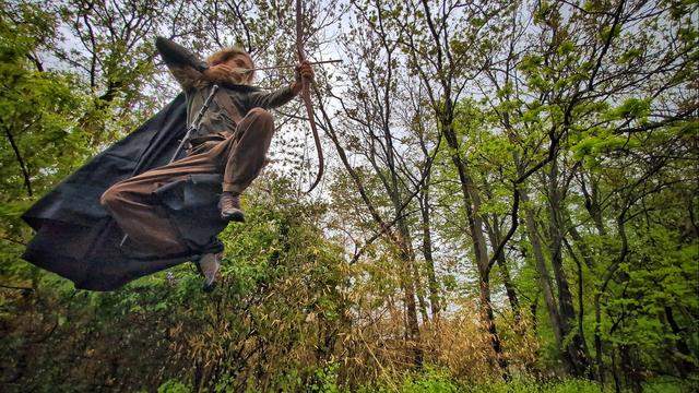 Photo of my son flying through the air with a cape and bow & arrow