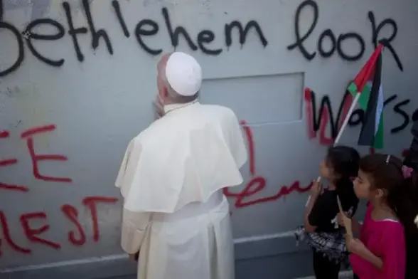 Pope Francis prays during his visit to the West Bank in 2014.Credit: AP
