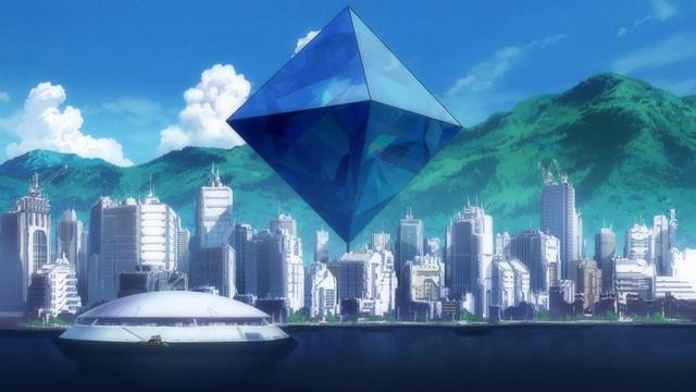 A diamond shaped object floating near a city skyline.