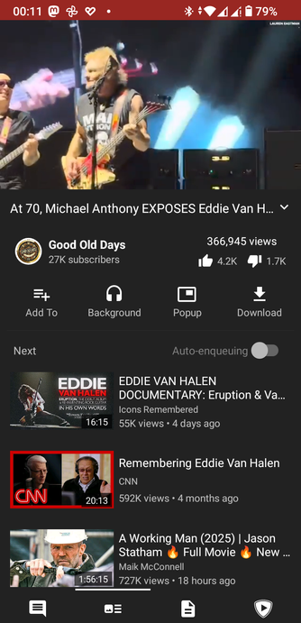 The screencap is a screenshot of a YouTube video page, viewed in tubular Android client. At the top, there is a video thumbnail showing two musicians on stage, one playing a guitar and the other a bass guitar. The video title reads "At 70, Michael Anthony EXPOSES Eddie Van H...". The channel name is "Good Old Days" with 27K subscribers, and the video has 366,945 views, 4.2K likes, and 1.7K dislikes. Below the video, there are options to add to playlist, play in background, open in popup, and download. The next video in the playlist is a documentary titled "EDDIE VAN HALEN DOCUMENTARY: Eruption & Va... Icons Remembered" with 55K views and posted 4 days ago. The following video is a CNN segment titled "Remembering Eddie Van Halen" with 592K views and posted 4 months ago. The last video in the list is "A Working Man (2025) | Jason Statham Full Movie 🔥 New..." with 727K views and posted 18 hours ago. The bottom of the screen shows the YouTube interface with a chat icon, a menu icon, a document icon, and a play icon.

 Ovis2-8B

🌱 Energy used: 0.315 Wh